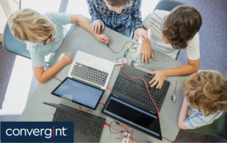 group of kids working on laptops